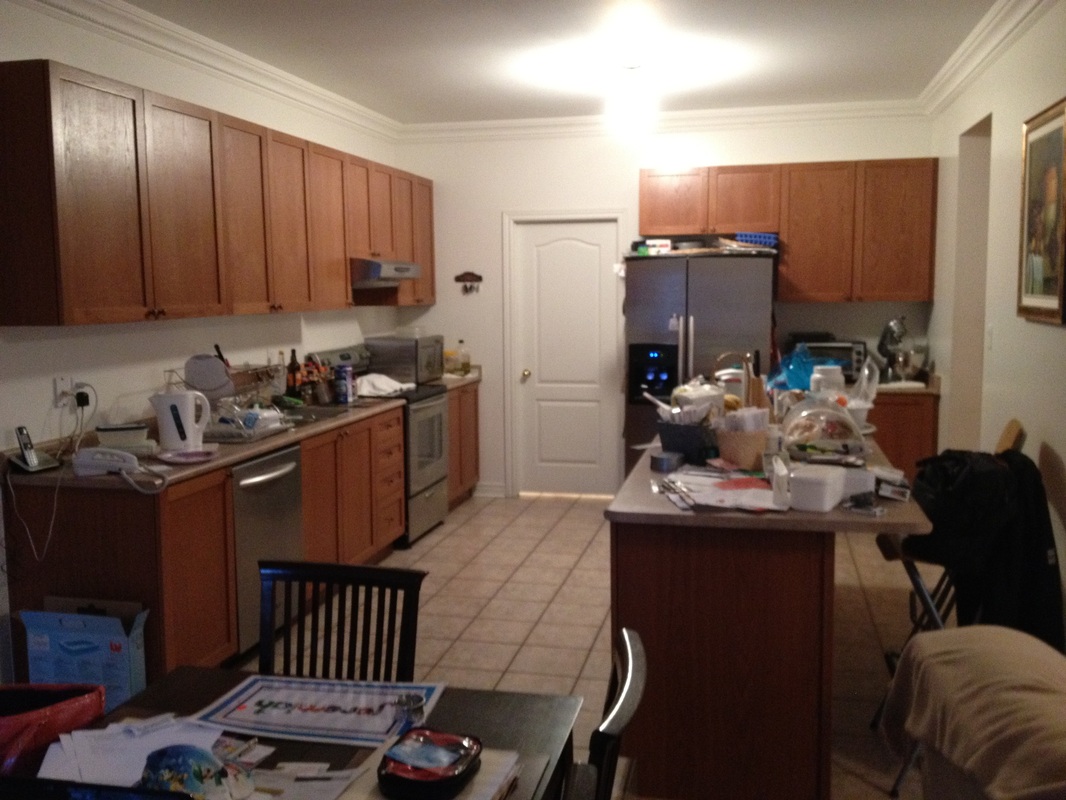 A messy kitchen with brown cabinets