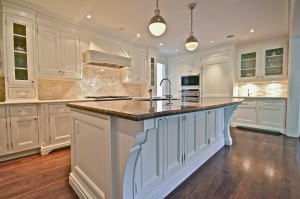 A big kitchen with white cabinets and a marble countertop