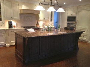 A simple kitchen with a dark brown countertop