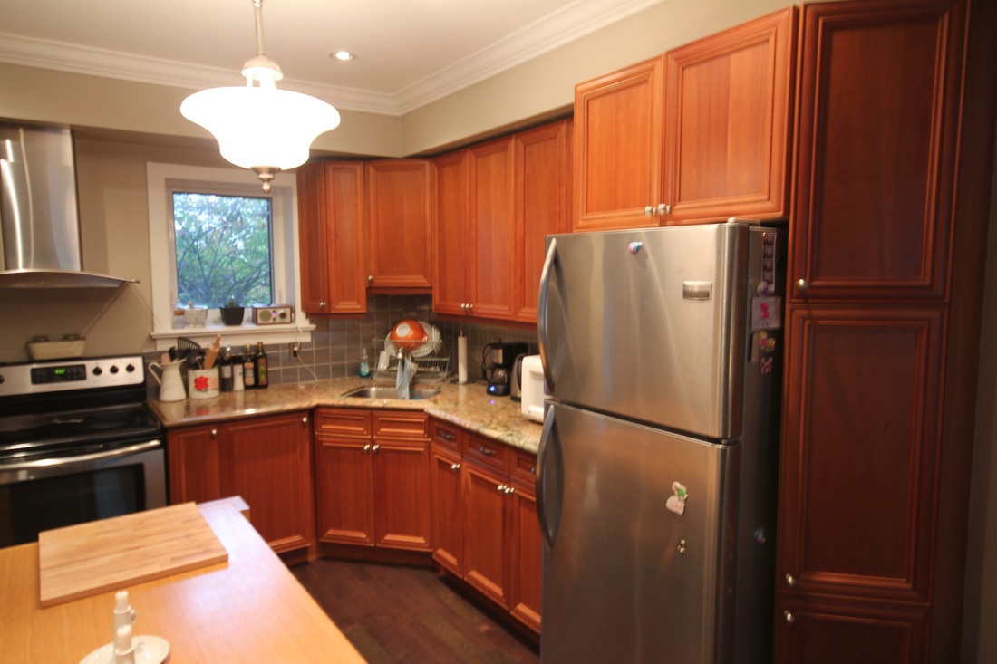 An ordinary kitchen with brown cabinets