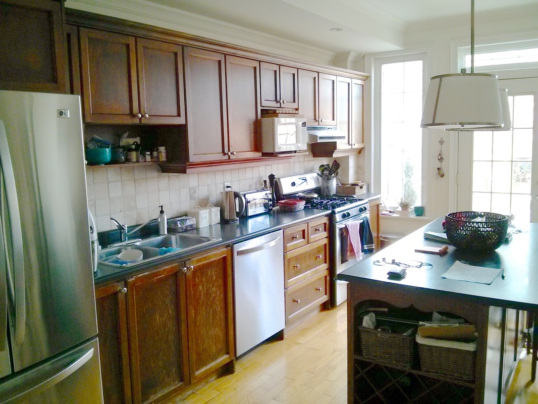 A typical kitchen with a cluttered countertop and sink
